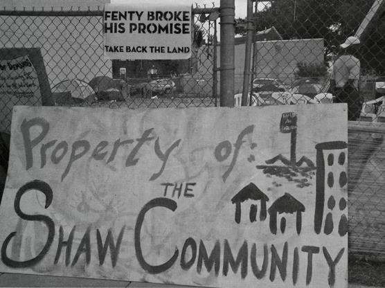 protest sign:  Property of the Shaw Community